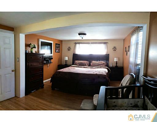 128 Raritan Boulevard Old Bridge, NJ 07735 - Photo 7 of 15 a bedroom with a bed and a television