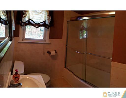 128 Raritan Boulevard Old Bridge, NJ 07735 - Photo 10 of 15 a bathroom with a toilet and a shower curtain