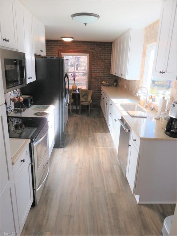 6304 Hunt Road Pleasant Garden, NC 27313 - Photo 4 of 29 Totally updated TRES CHIC kitchen with brick accent wall