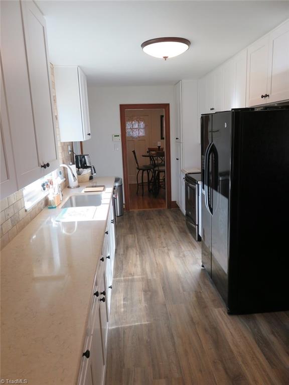 6304 Hunt Road Pleasant Garden, NC 27313 - Photo 5 of 29 NEW cabinets, Cortz countertops, appliances, flooring, under counter lighting