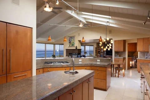 a view of a kitchen with stainless steel appliances granite countertop a sink and cabinets