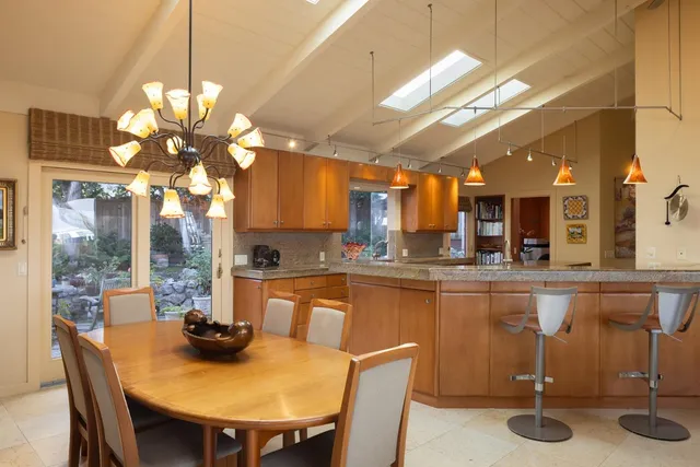 a kitchen with stainless steel appliances granite countertop a sink a stove and a refrigerator