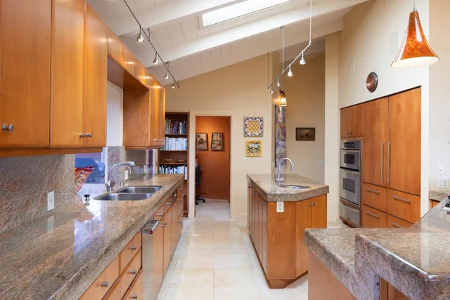 a living room with furniture and large windows