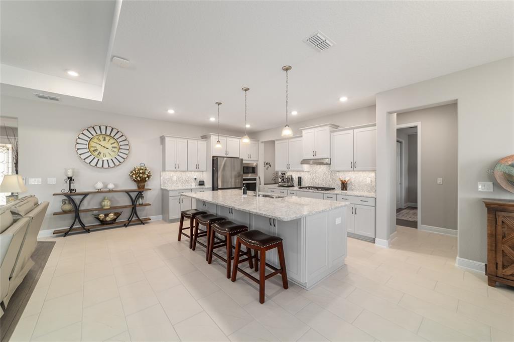 9681 Southwest 82nd Street Road Ocala, FL 34481 - Photo 13 of 62 a large white kitchen with a large window and stainless steel appliances