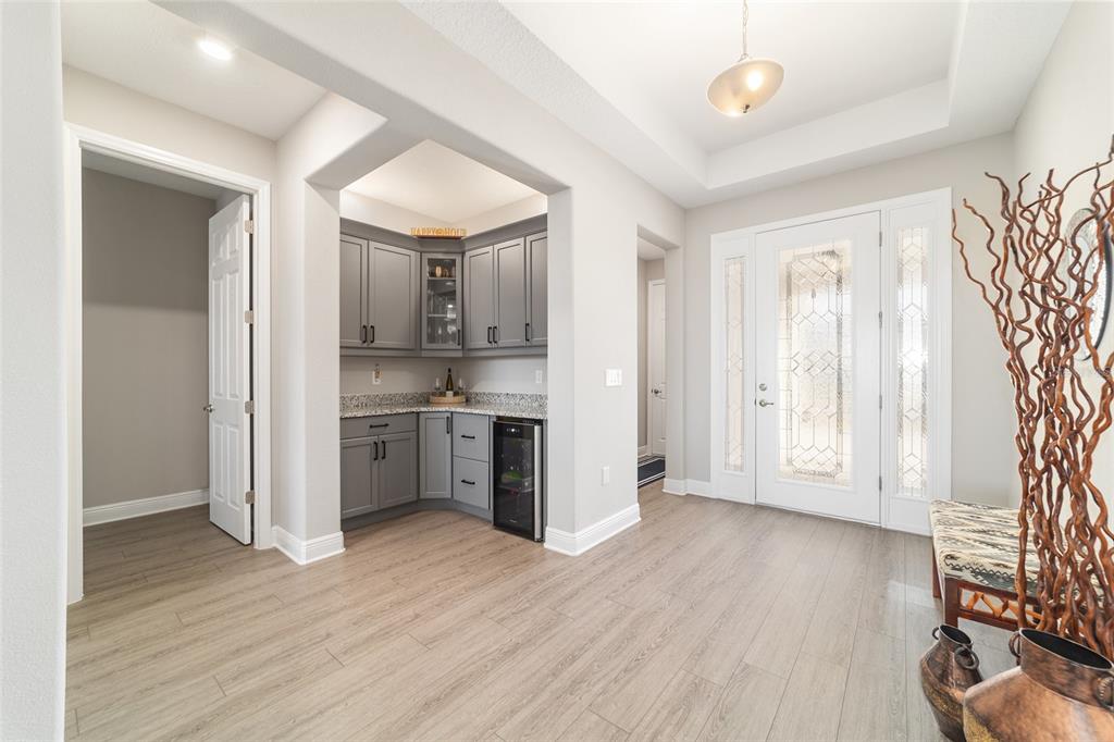 9681 Southwest 82nd Street Road Ocala, FL 34481 - Photo 19 of 62 a view of a kitchen with a sink and dishwasher a refrigerator with wooden floor