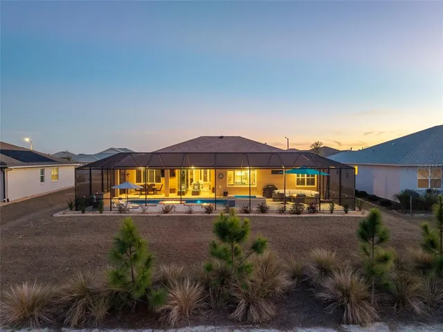 a swimming pool with outdoor seating and yard