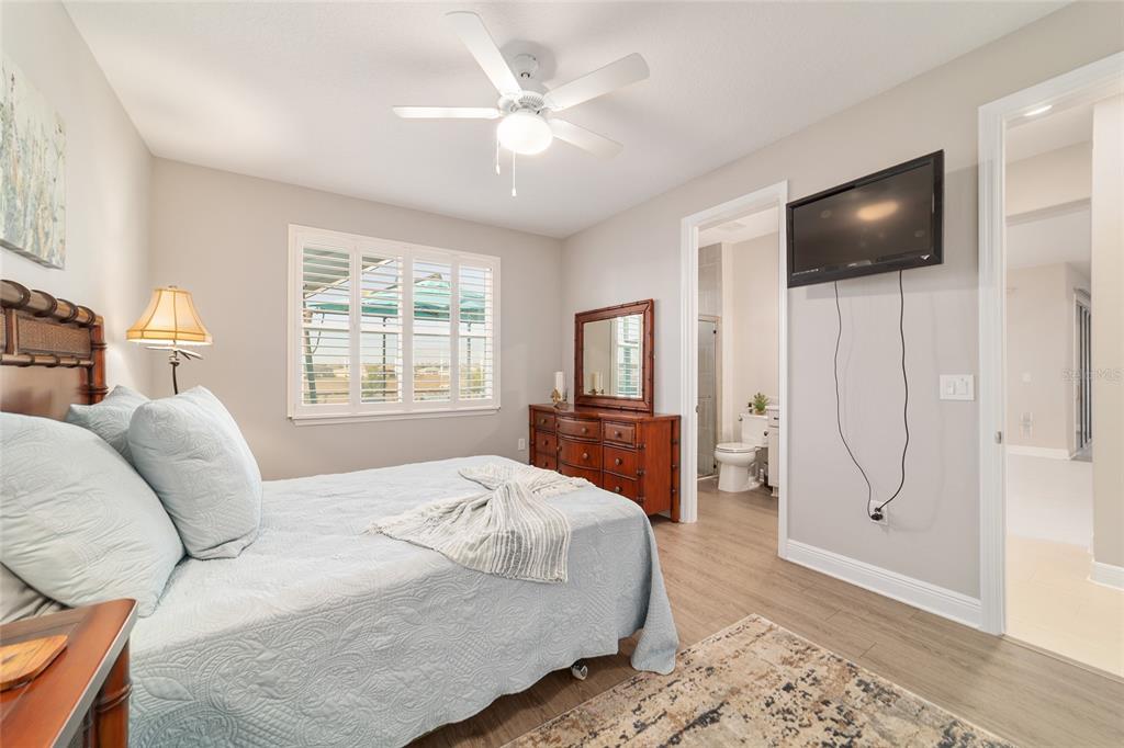 9681 Southwest 82nd Street Road Ocala, FL 34481 - Photo 29 of 62 a bedroom with a bed television on desk and a window
