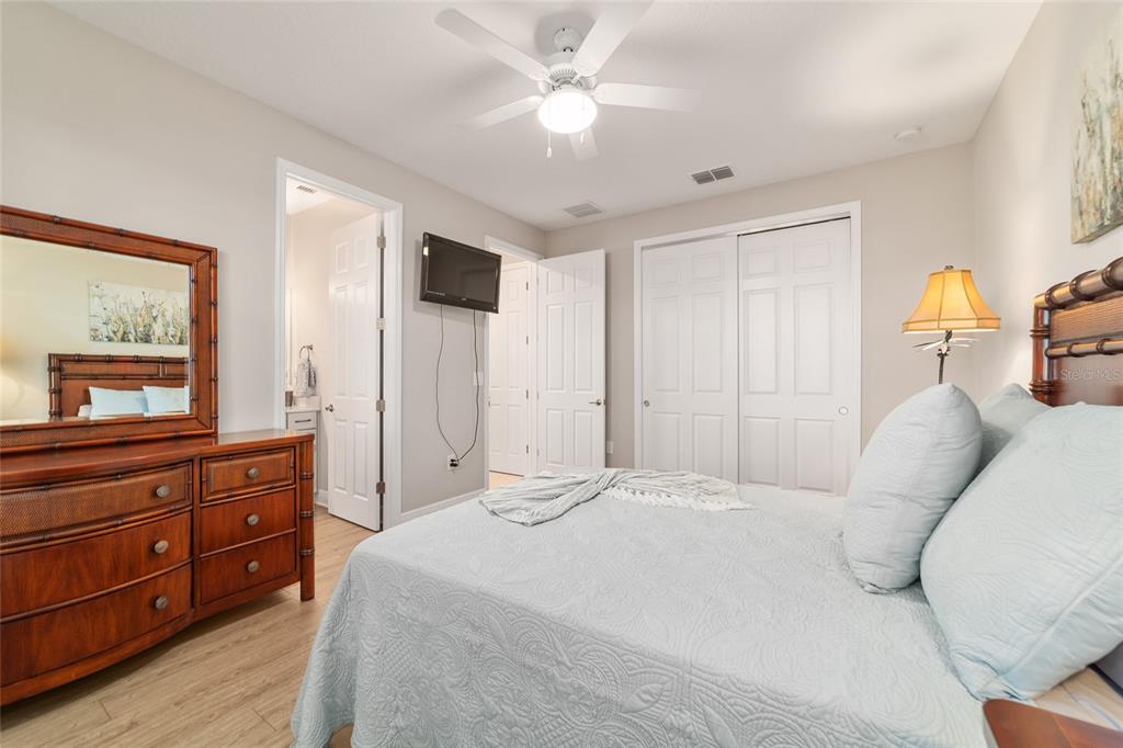 9681 Southwest 82nd Street Road Ocala, FL 34481 - Photo 30 of 62 a bedroom with a bed and a chandelier