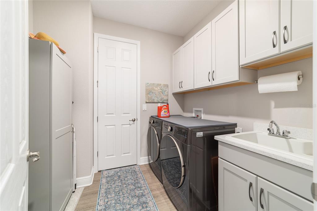 9681 Southwest 82nd Street Road Ocala, FL 34481 - Photo 32 of 62 a utility room with sink dryer and washer