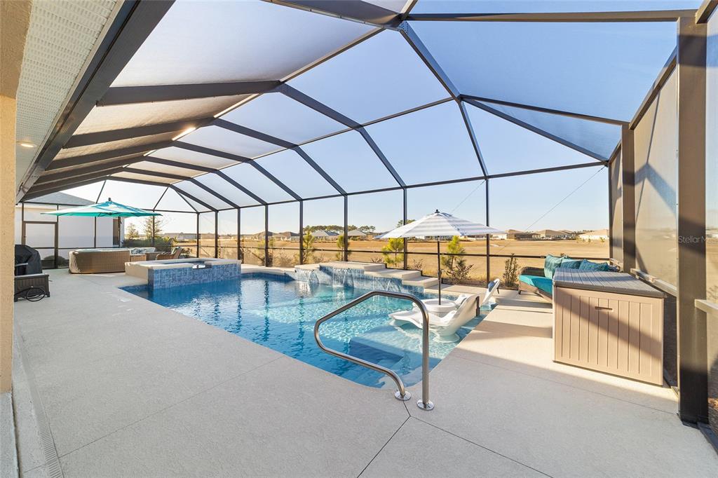 9681 Southwest 82nd Street Road Ocala, FL 34481 - Photo 38 of 62 a view of a swimming pool with a lounge chairs