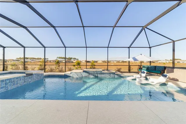 a view of a roof deck with couches under an umbrella