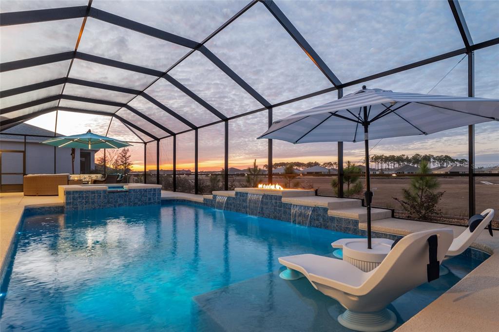9681 Southwest 82nd Street Road Ocala, FL 34481 - Photo 4 of 62 a view of a swimming pool with a couches in a patio