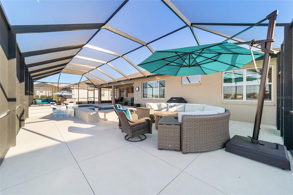 9681 Southwest 82nd Street Road Ocala, FL 34481 - Photo 43 of 62 a view of a patio with a table and chairs under an umbrella