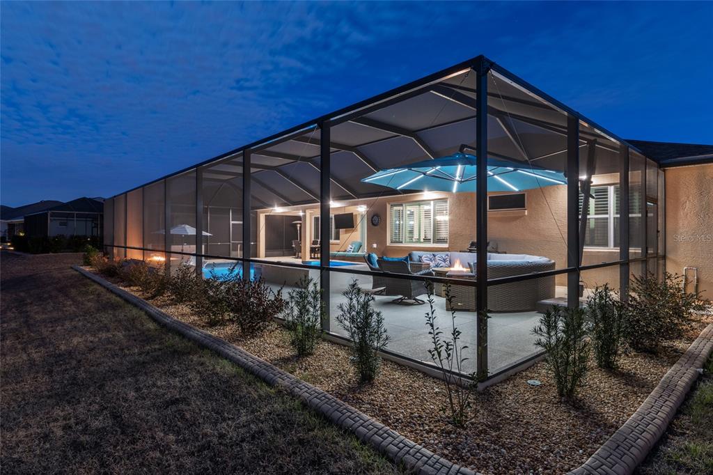 9681 Southwest 82nd Street Road Ocala, FL 34481 - Photo 61 of 62 a view of a chair and table in the backyard