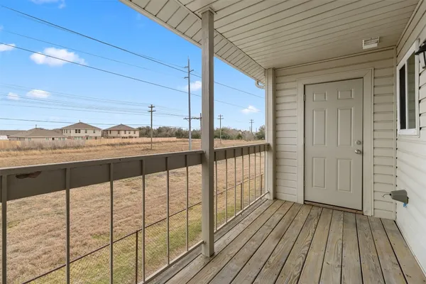 a view of a balcony with furniture