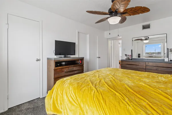 a bed room with a bed and a television