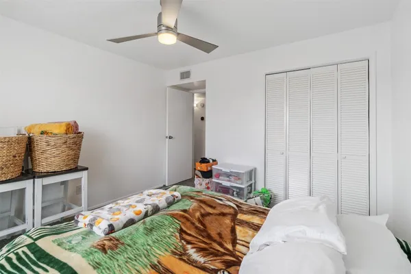 a bedroom with a bed and chandelier