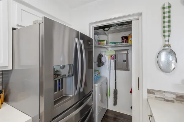 a view of a kitchen with refrigerator and washer