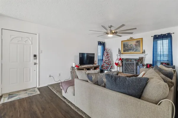 a living room with fireplace furniture and a flat screen tv