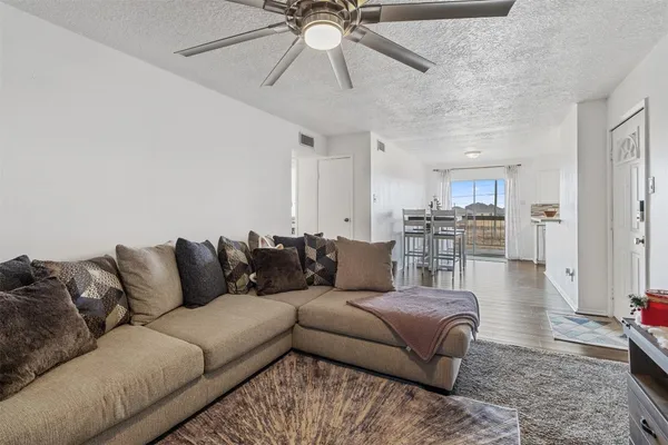 a living room with furniture and kitchen view