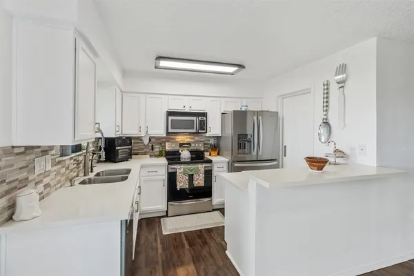 a kitchen with a sink stove and refrigerator