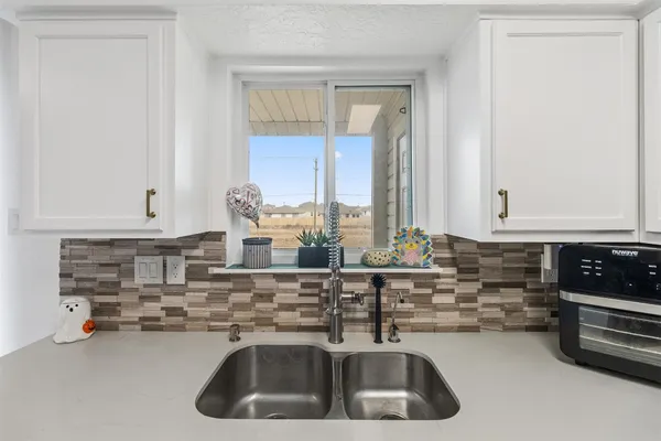 a kitchen with a sink and cabinets