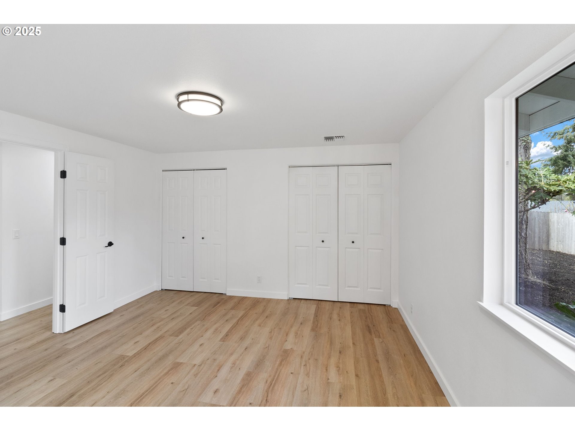 6508 E Street Springfield, OR 97478 - Photo 18 of 35 a view of an empty room with wooden floor and a window