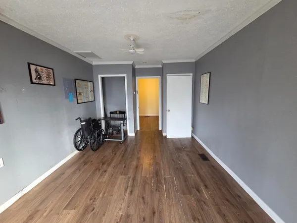 a view of a room with wooden floor