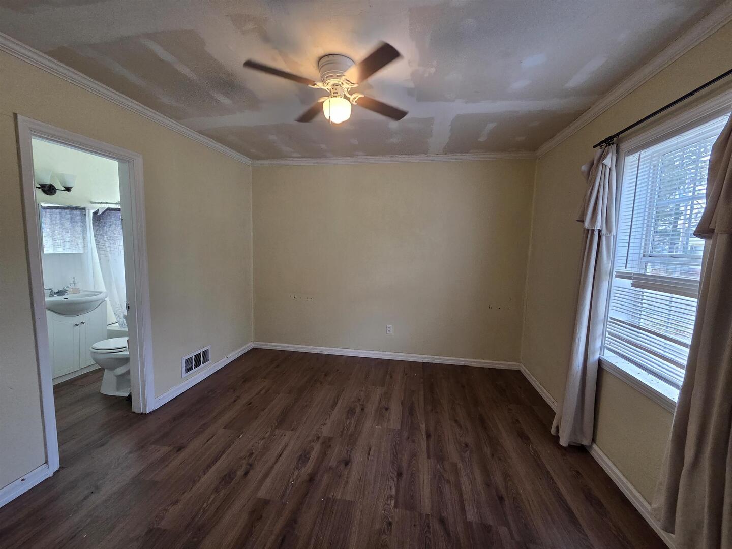 710 South Main Street Harrisburg, IL 62946 - Photo 9 of 18 wooden floor in an empty room with a window