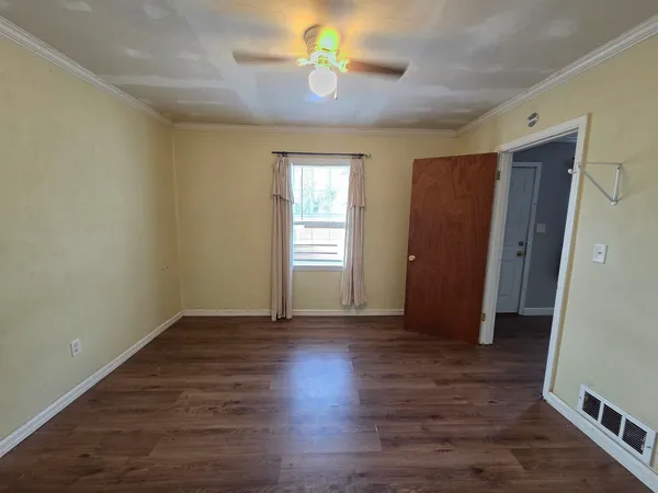 wooden floor in an empty room with a window