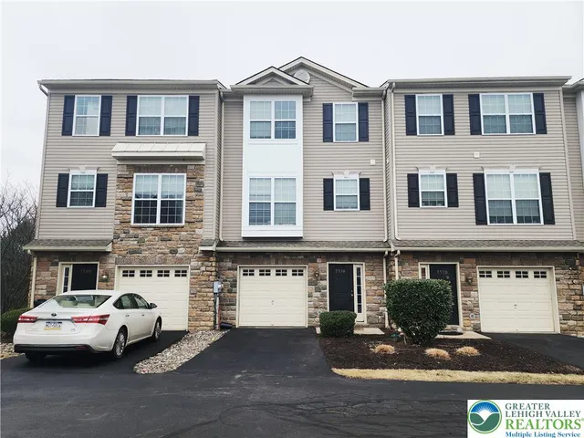 a view of a street that has couple of cars parked