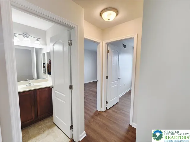 a spacious bathroom with a granite countertop sink and a mirror