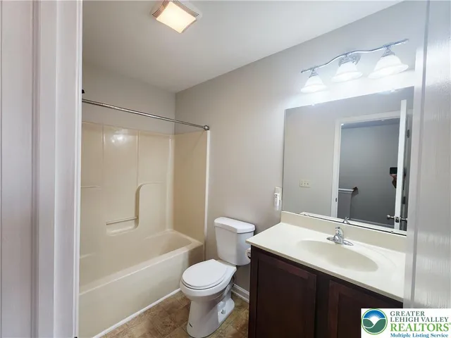 a bathroom with a sink toilet a mirror and shower