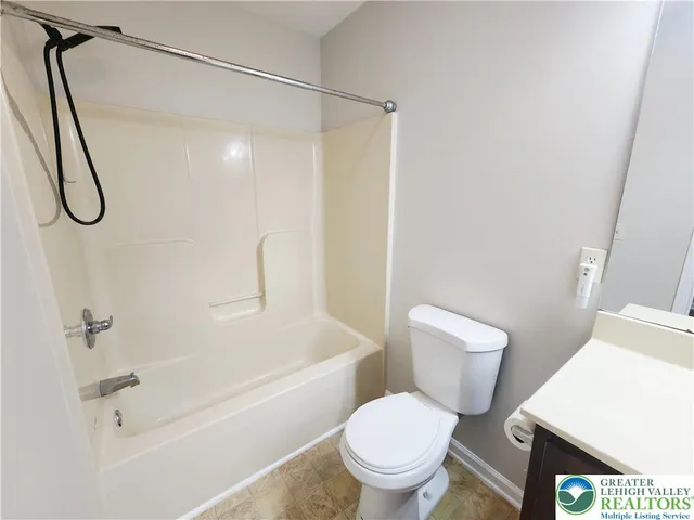 a white toilet sitting next to a bath tub shower