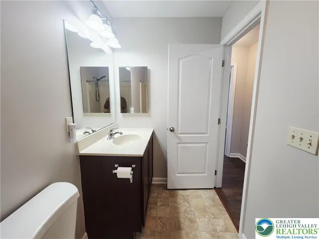 a bathroom with a sink a toilet and mirror