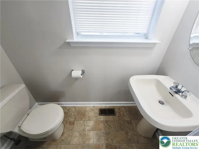 a bathroom with a toilet and a sink