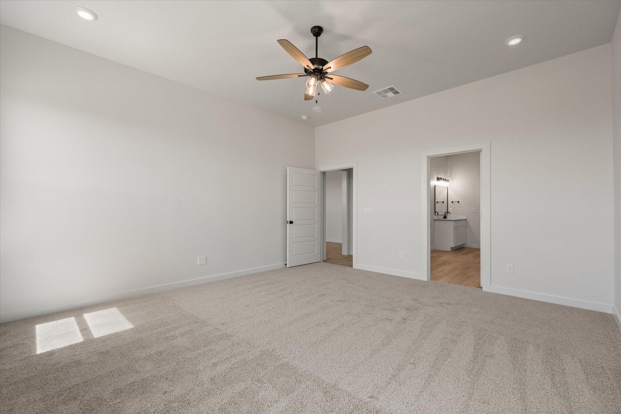 6101 121st Street Lubbock, TX 79424 - Photo 17 of 29 an empty room and a chandelier fan in a room