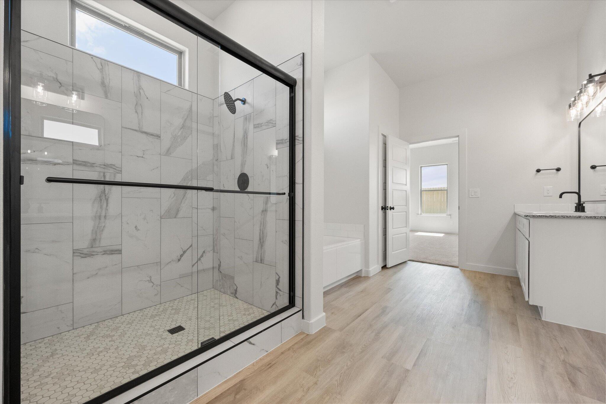 6101 121st Street Lubbock, TX 79424 - Photo 19 of 29 a bathroom with a glass shower door