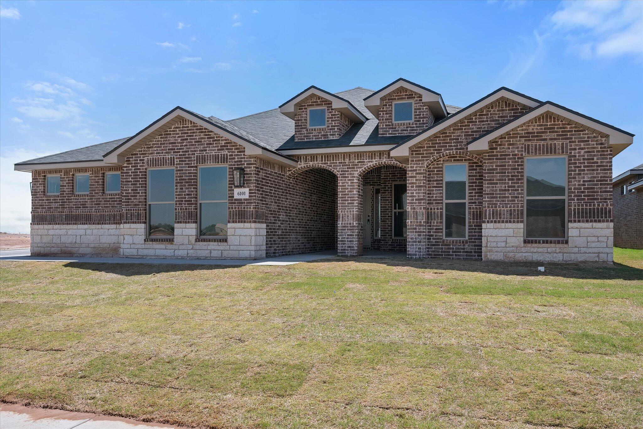 6101 121st Street Lubbock, TX 79424 - Photo 2 of 29 a front view of a house with yard and garage