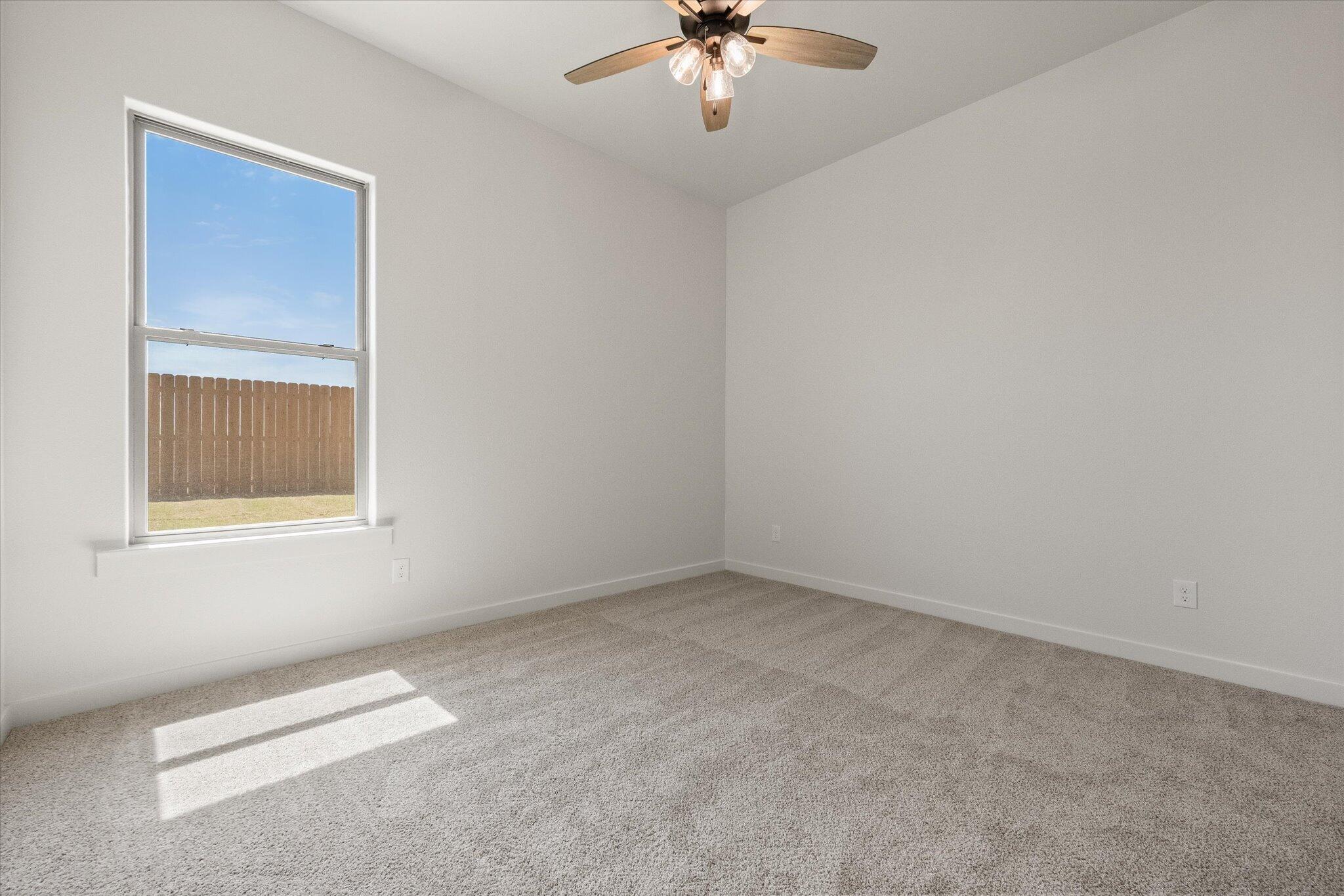 6101 121st Street Lubbock, TX 79424 - Photo 21 of 29 an empty room with a chandelier fan