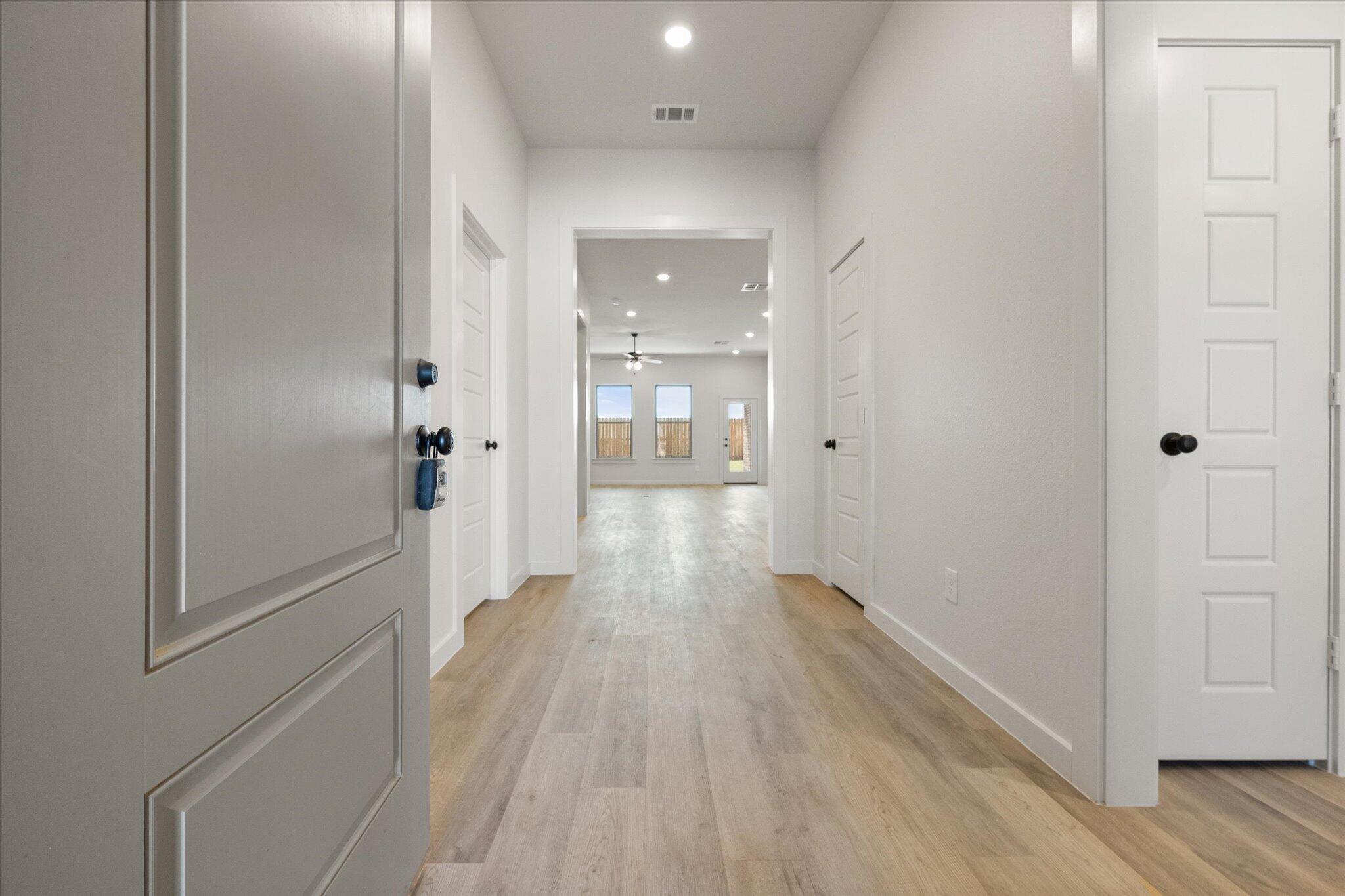 6101 121st Street Lubbock, TX 79424 - Photo 3 of 29 a view of a hallway with wooden floor