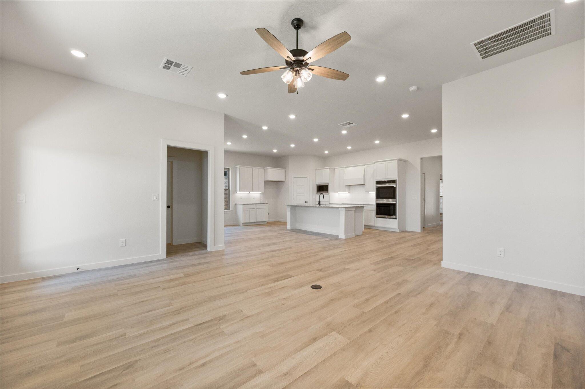 6101 121st Street Lubbock, TX 79424 - Photo 7 of 29 a view of an empty room with a kitchen