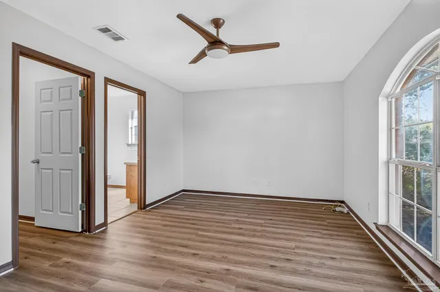 wooden floor in an empty room with a window
