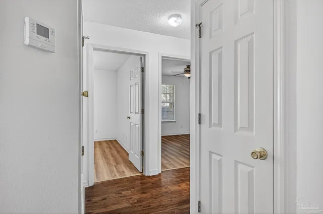 a view of hallway with wooden floor