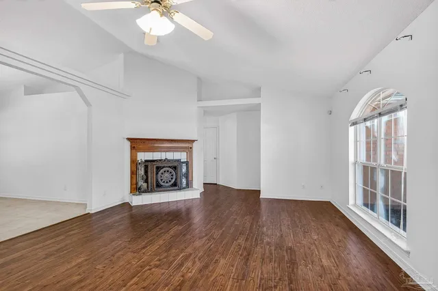 a view of a livingroom with wooden floor and a ceiling fan