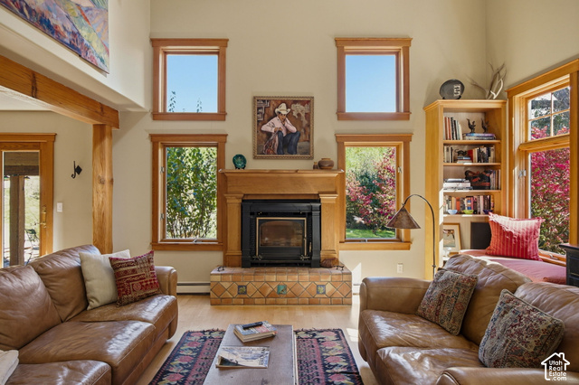 725 Canyon Road Smithfield, UT 84335 - Photo 18 of 100 Wood-finish flooring with a fireplace featuring a tile hearth and wood mantel