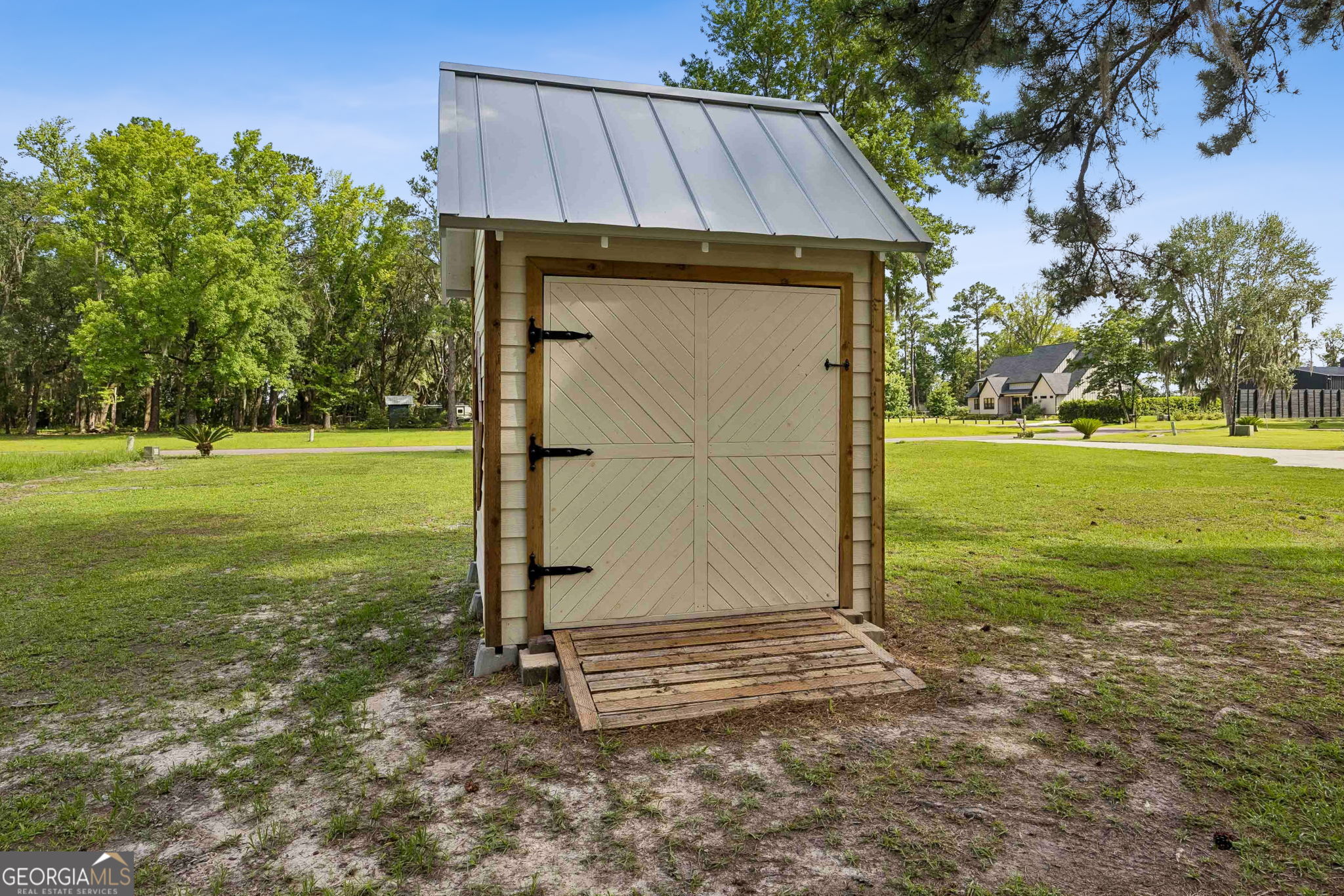 706 Hopewell Point Road White Oak, GA 31568 - Photo 80 of 84 A detached storage building provides convenient space for tools, lawn equipment, seasonal decor, and outdoor essentials.