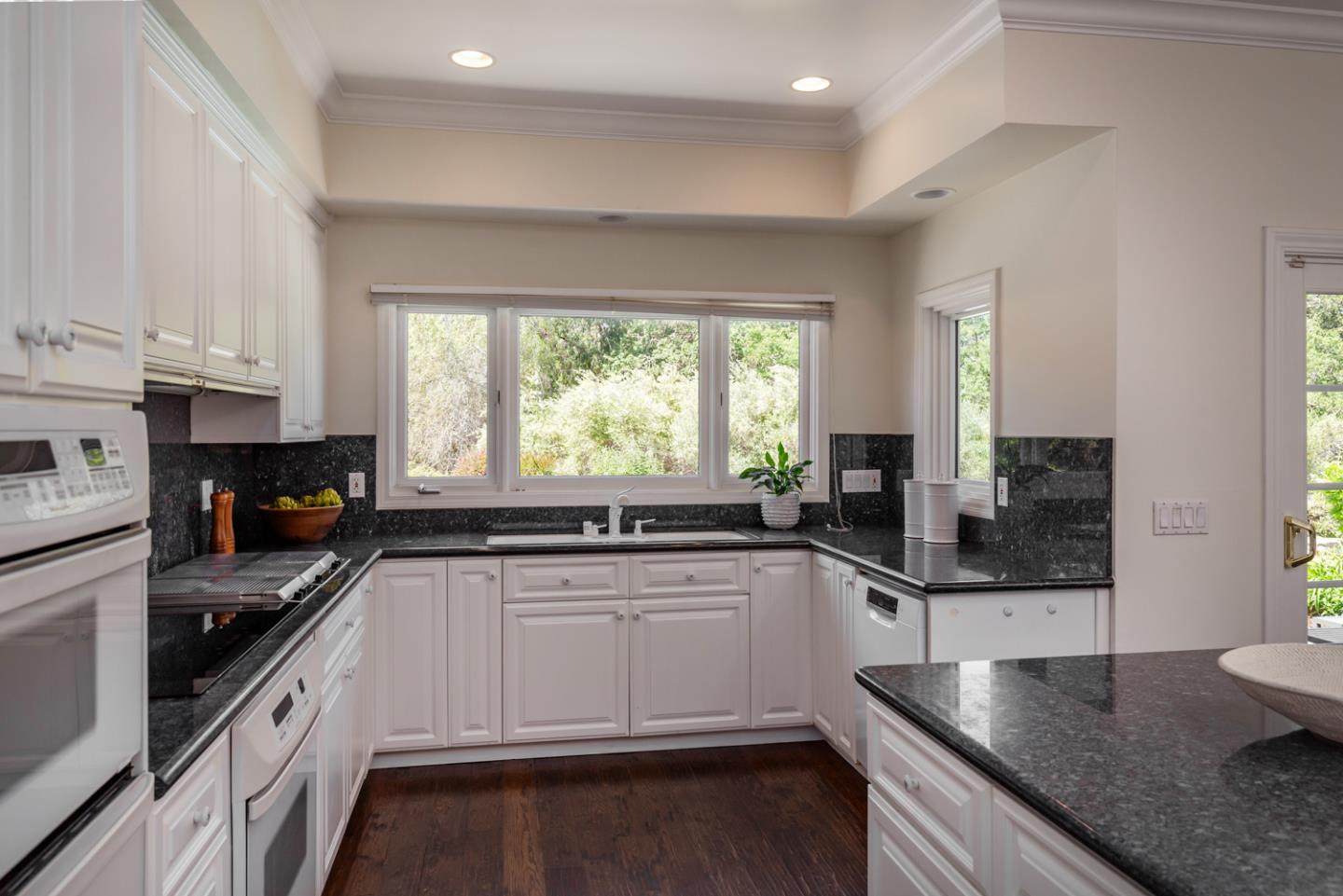 1210 Cañada Road Woodside, CA 94062 - Photo 11 of 60 a kitchen with stainless steel appliances wooden cabinets and a stove