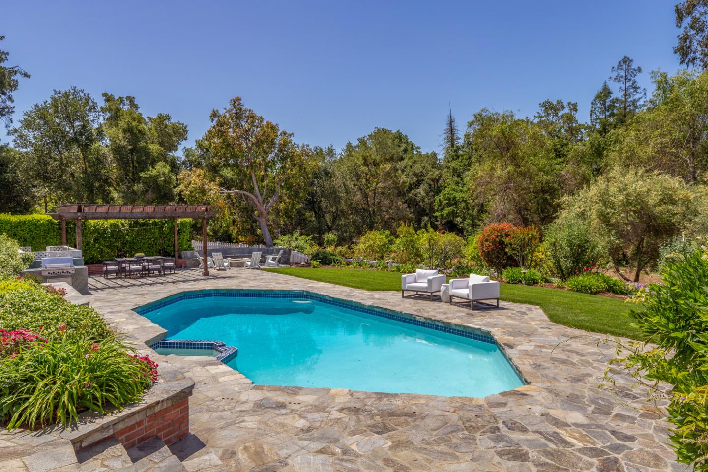 1210 Cañada Road Woodside, CA 94062 - Photo 37 of 60 a view of a swimming pool and lounge chairs
