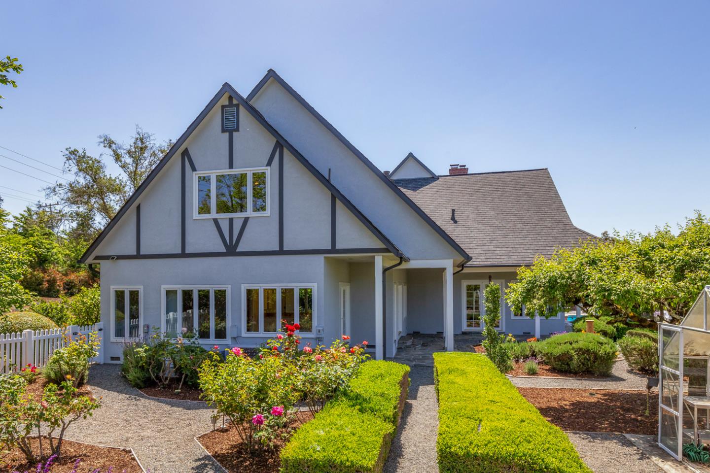 1210 Cañada Road Woodside, CA 94062 - Photo 41 of 60 a front view of a house with a yard and potted plants